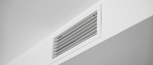 White ventilation grille on a wall