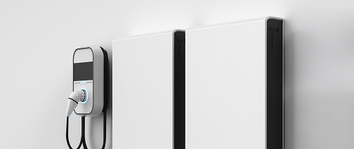 Wall-mounted battery storage units beside an EV charger